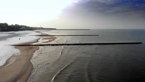 Aerial-shot-of-sandy-beach-in-Ustka-in-winter