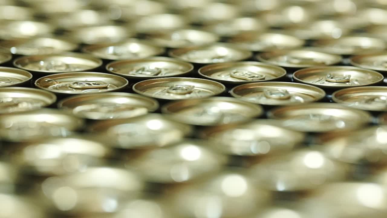 Golden can tops in a beverage factory