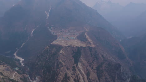 phortse village view from mongla view point drone shot at high altitude landscape with trekking trails and adventurous travel and tourism of nepal. unclear weather signals global warming