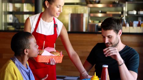 waitress serving food to customers