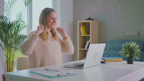 mujer exitosa bailando en el escritorio