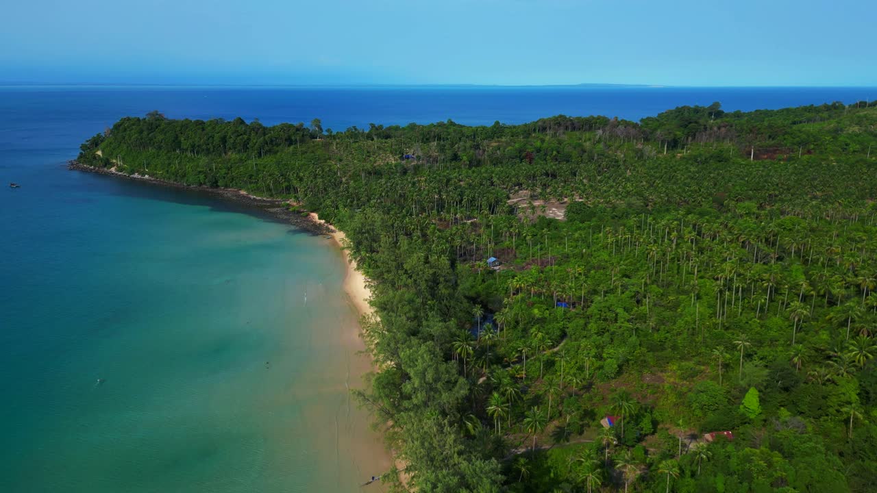 lonely beach with turquoise water and green forest in Koh Rong, Cambodia. Majestic aerial view flight drone shot footage from above