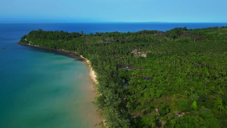 lonely beach with turquoise water and green forest in koh rong, cambodia. majestic aerial view flight drone shot footage from above