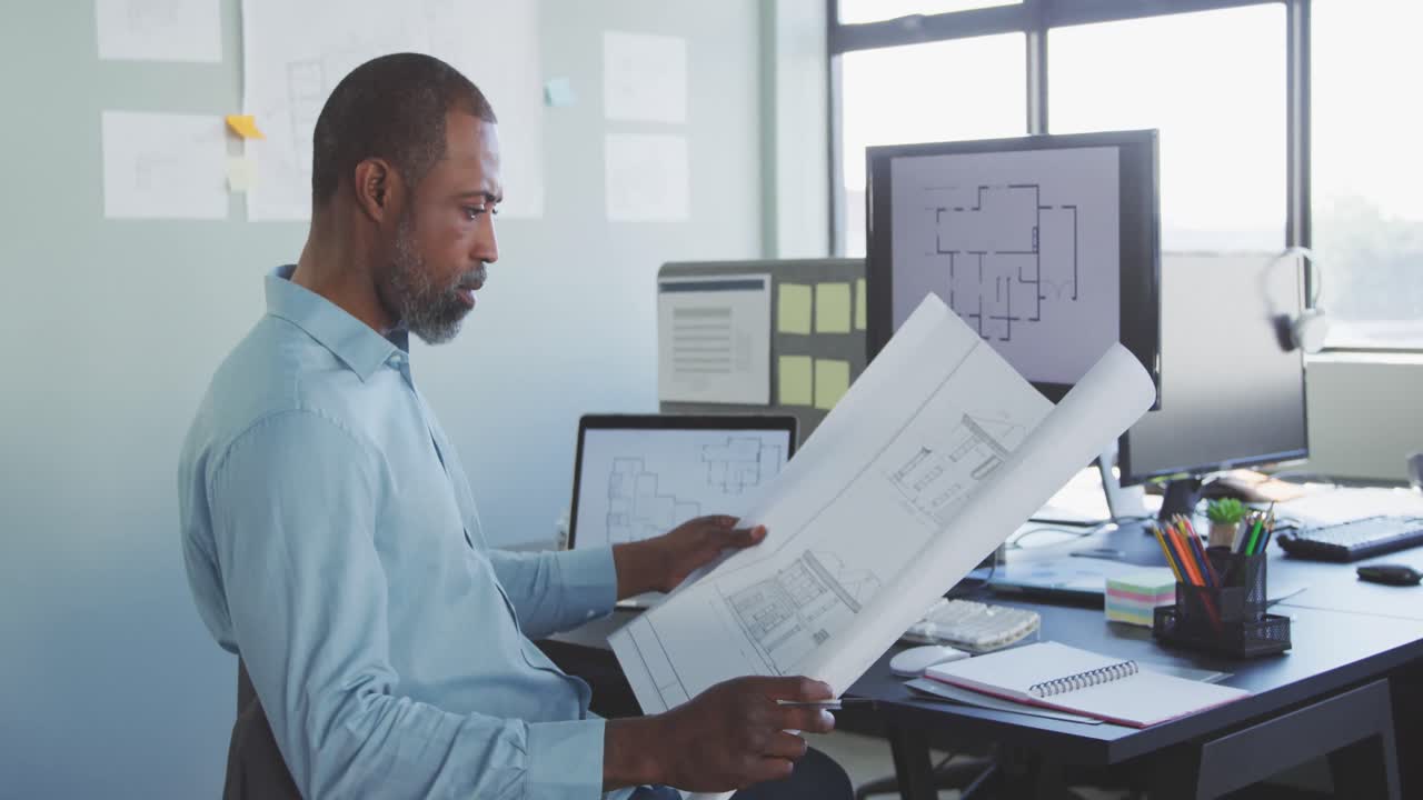 Businessman looking at building project in modern office