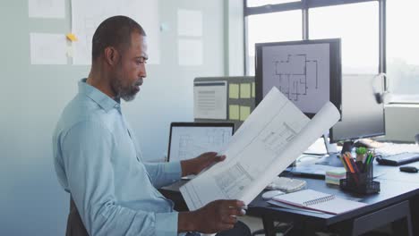 businessman looking at building project in modern office