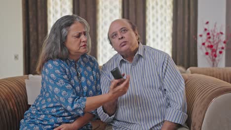 Old-Indian-couple-fighting-for-TV-remote