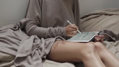 woman using tablet in bed