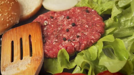 fresh beef for burger on the table with lettuce onion and bread