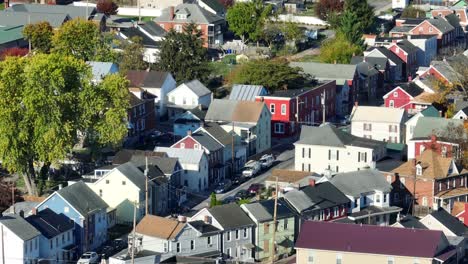 Aerial-view-of-dense,-colorful-residential-area-with-mixed-housing-styles-and-autumn-trees-in-USA-city