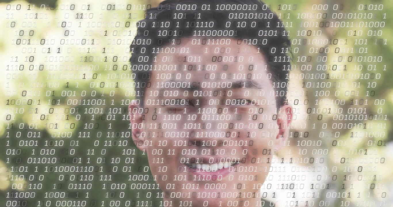 Adult man standing facing camera as bits overlaying face and intensifying, showing data immersion