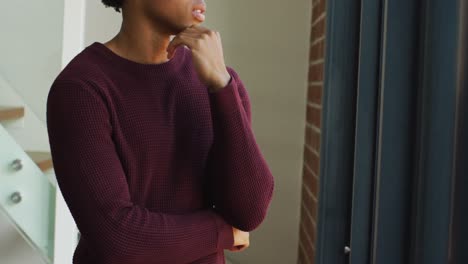 worried african american man is looking at the window