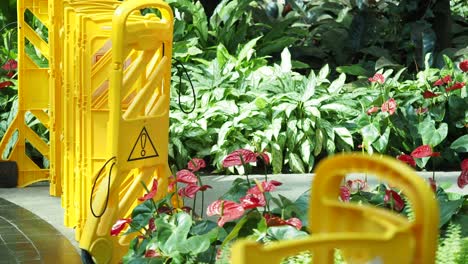 yellow folding barricade in a garden setting