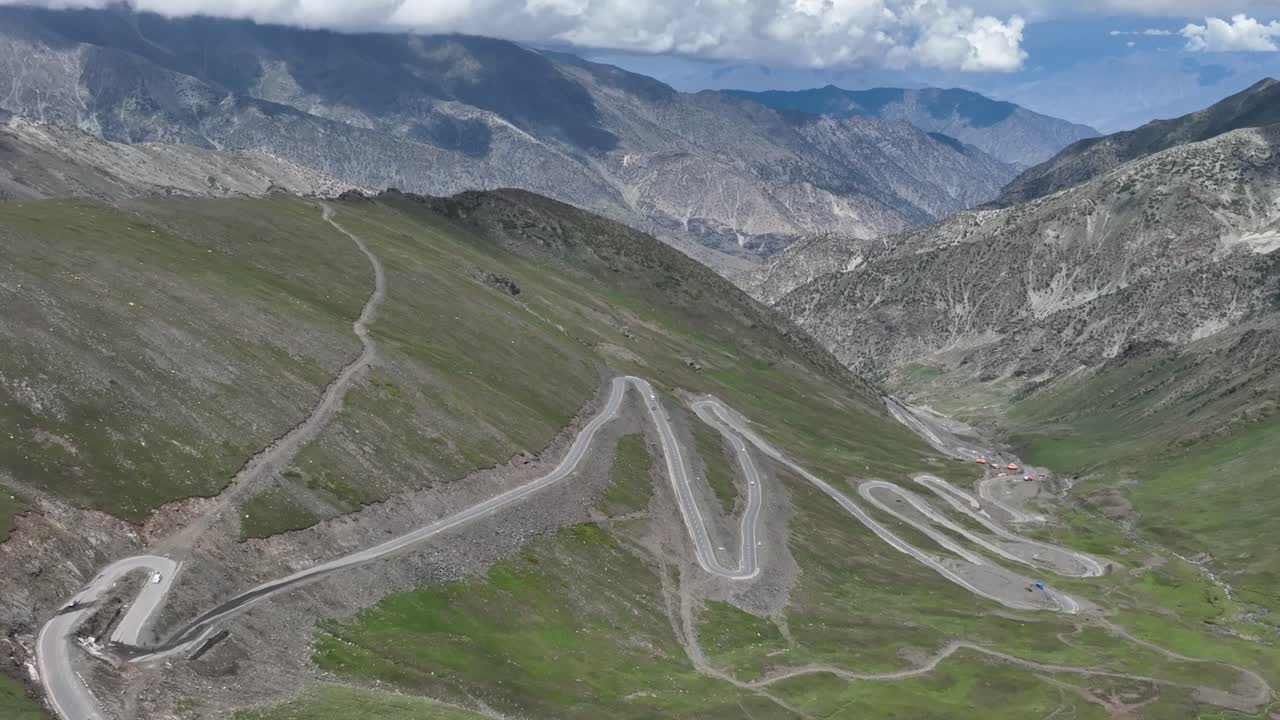 A drone retreats sideways near Babusar Pass, revealing the sweeping vistas and rugged terrain of this stunning mountain pass in Northern Pakistan