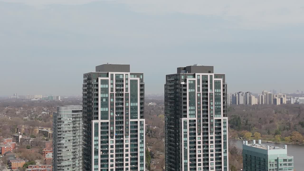High rise condo towers in Toronto overlooking the waterfront and surrounding neighborhoods, aerial pullback