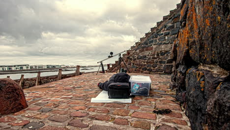 Time-lapse-of-content-creator-waiting-for-motion-time-lapse-set-up-on-slider-to-finish---clouds-flying-through-sky-in-Guernsey