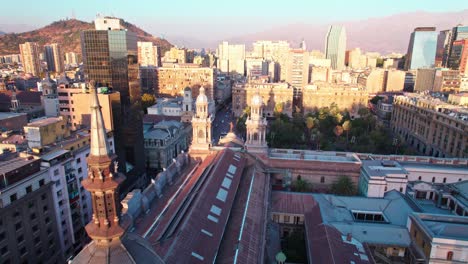 Aerial-dolly-overhead-Santiago-Metropolitan-Cathedral-and-Plaza-de-Armas-at-sunset