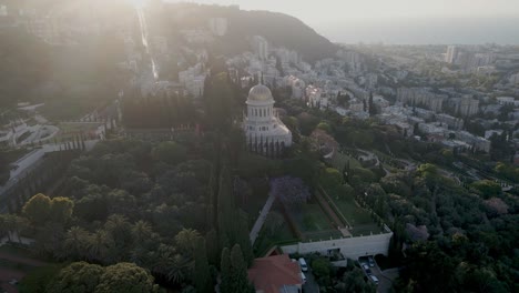 Aerial-push-in-toward-shrine-of-bab,-Haifa-bay-in-background