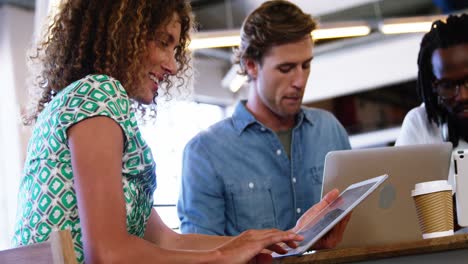 Smiling-woman-working-with-her-colleagues