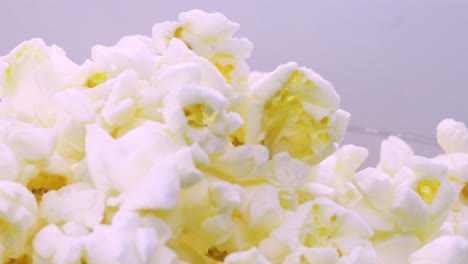 mountain-of-golden-butter-popcorn-rotating,-macro-shot-in-4k