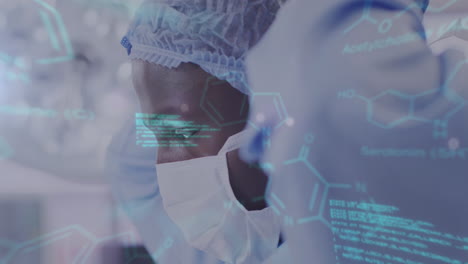 animation of medical data processing over african american male surgeon putting on face mask
