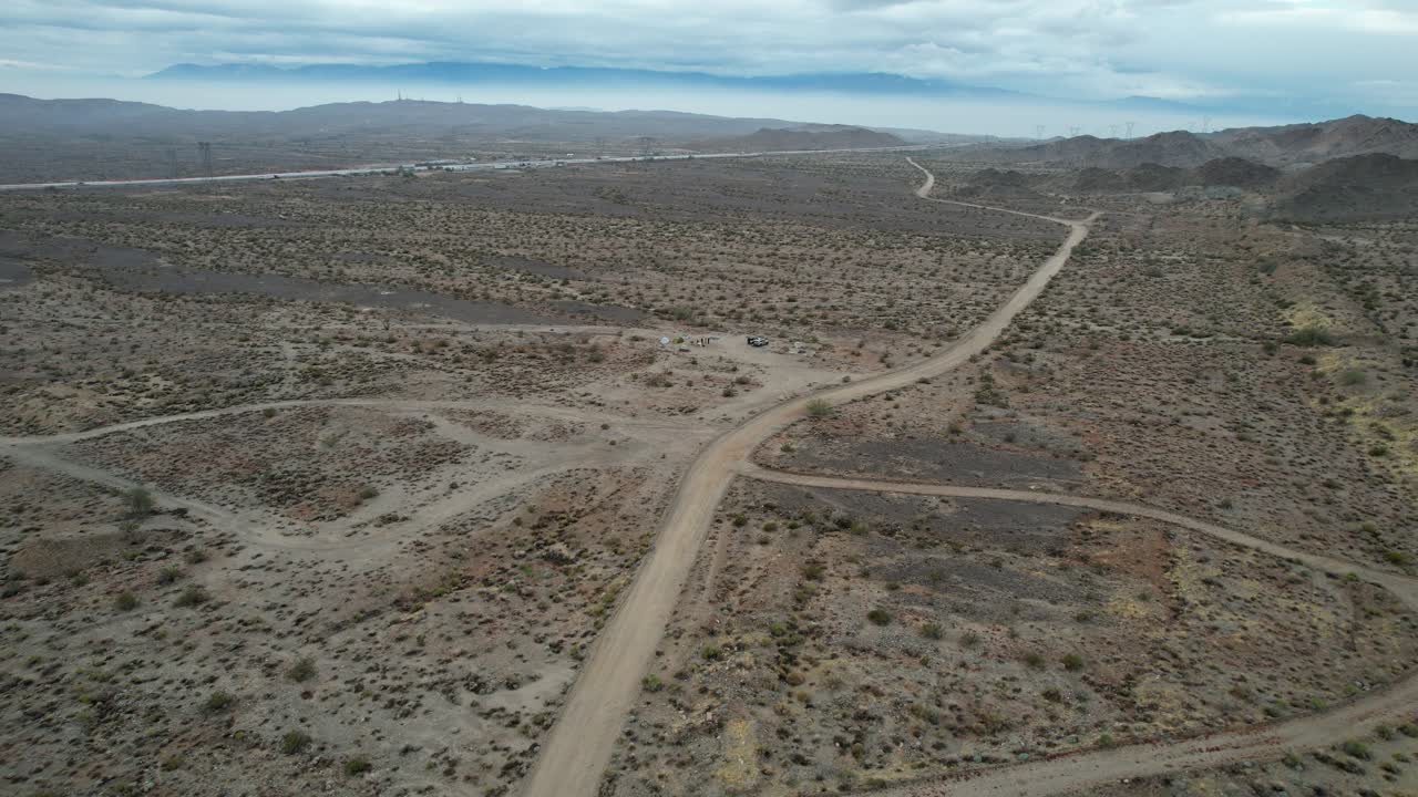 Nevada OHV (Off Highway Vehicles) Desert Trails Landscape; Aerial Tracking Shot Descending Over A Barren Landscape.