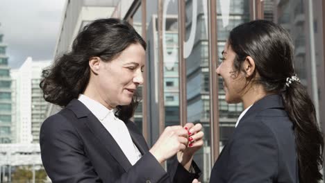 happy businesswomen greeting each other