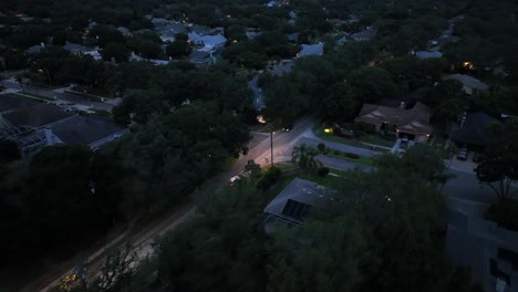cars driving on the main street of riverview community at night in florida, usa. - aerial shot