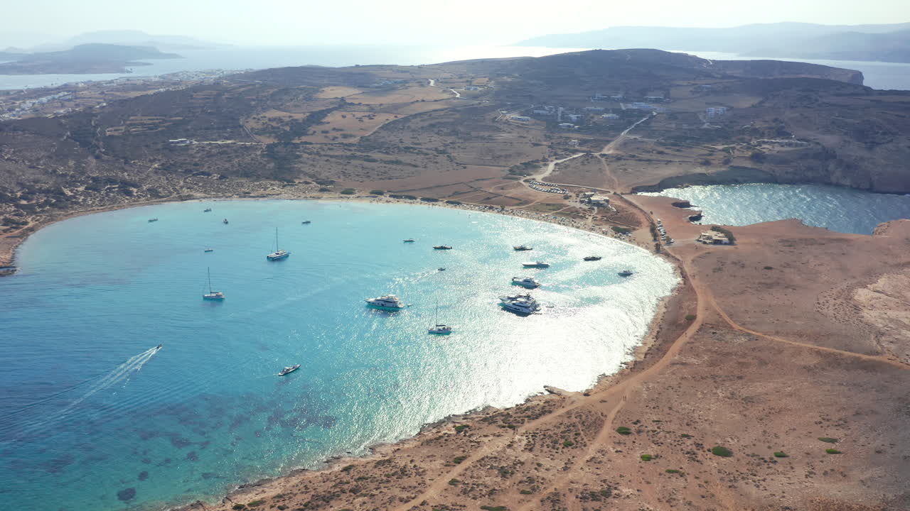 Clear water and golden sand line Pori Beach as seen from drone above Koufonisia shore