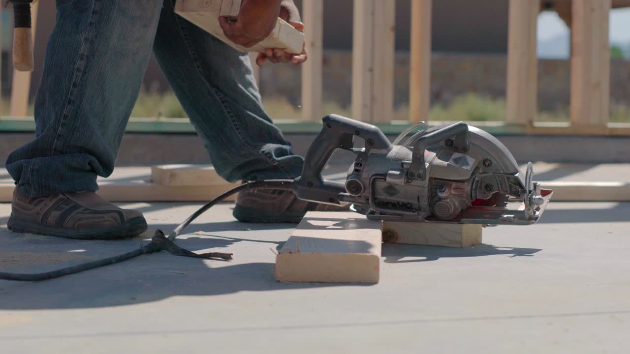 Worker Cuts Wood Partial Using Foot as Leverage