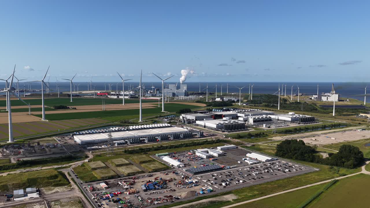 Daytime summer aerial drone video of a large-scale data center in the Eemshaven, The Netherlands, modern computing infrastructure, cloud technology, and high capacity digital processing facilities