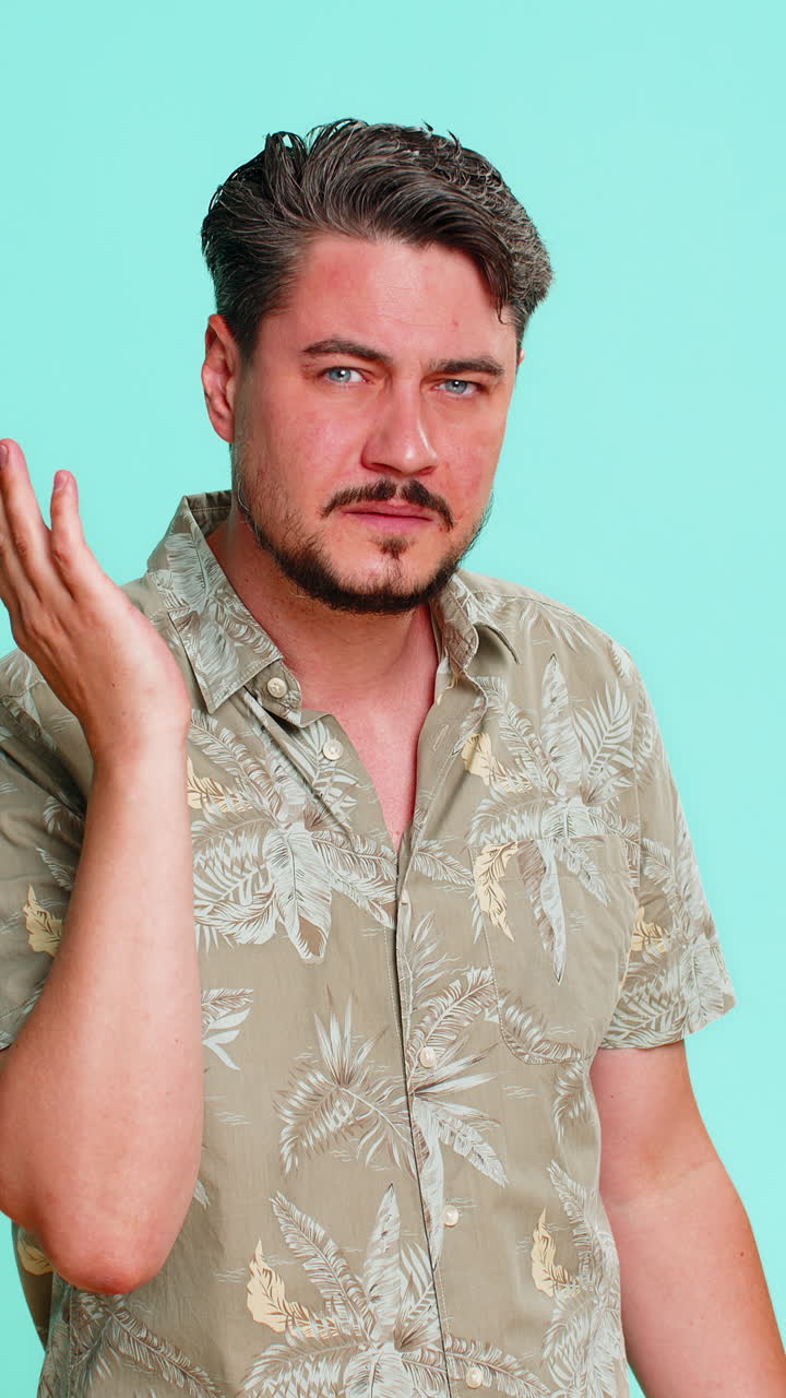 Adult man trying hear you looking confused and frowning keeping arm near ear for louder voice