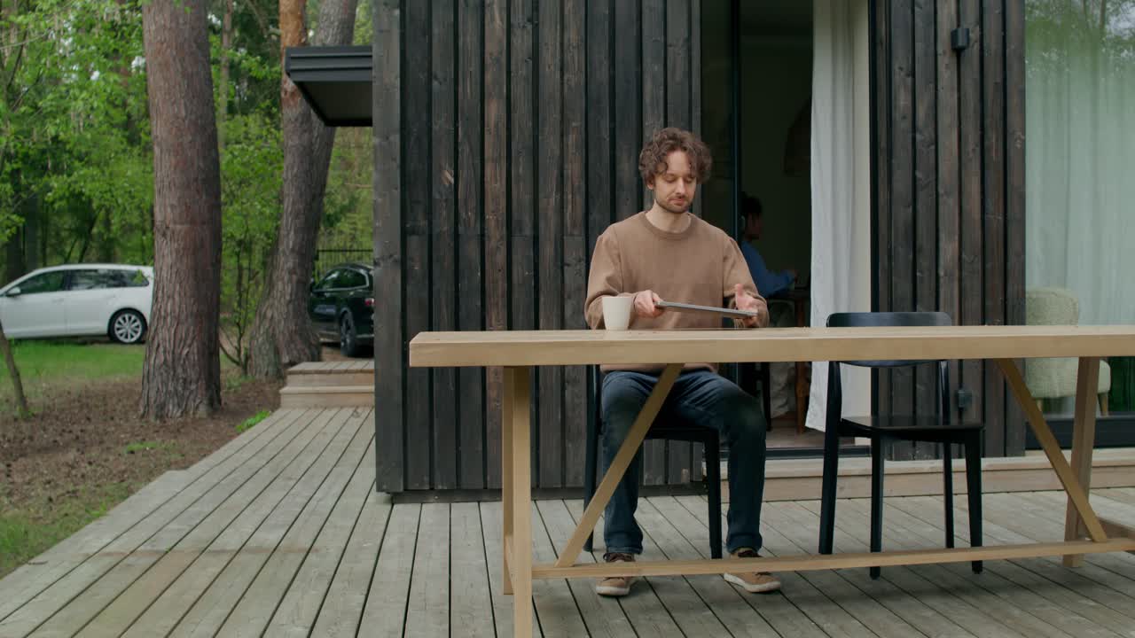 hombre trabajando en una computadora portátil en el patio al aire libre