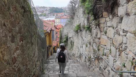 woman with backpack going down stairs in escadas do barrero