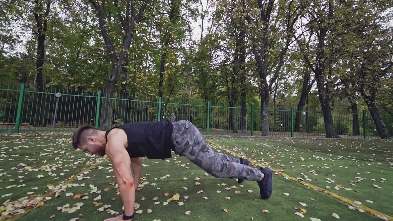 Active sportsman in the outdoor stadium. Strong man doing his workout in the open air. Slow motion. Healthy lifestyle.