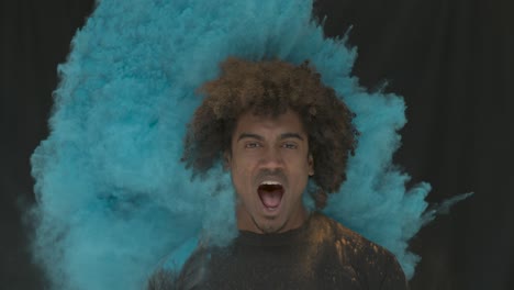 man in color powder explosion slow motion