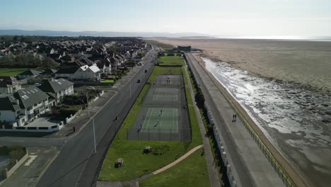 Hoylake-Beachfront-conservation-area-on-a-sunny-afternoon---aerial-drone-flyover-recreation-area-from-Meols,-Wirral,-UK