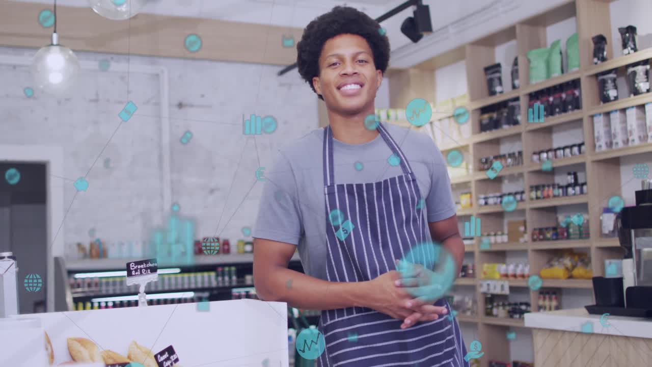 la animación de los iconos de los negocios sobre el asistente de tienda masculino biracial sonriendo.