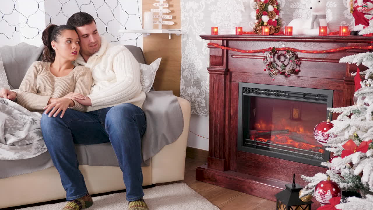 A couple celebrates Christmas together at home