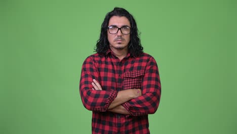 handsome hipster man smiling with arms crossed