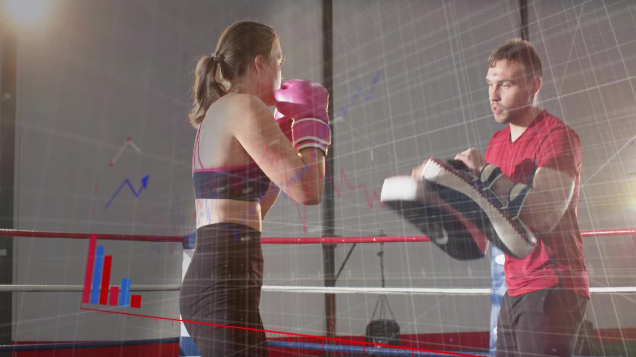 Coach cuing woman boxer kicking and punching with pads while data bars tracking strikes for boxing