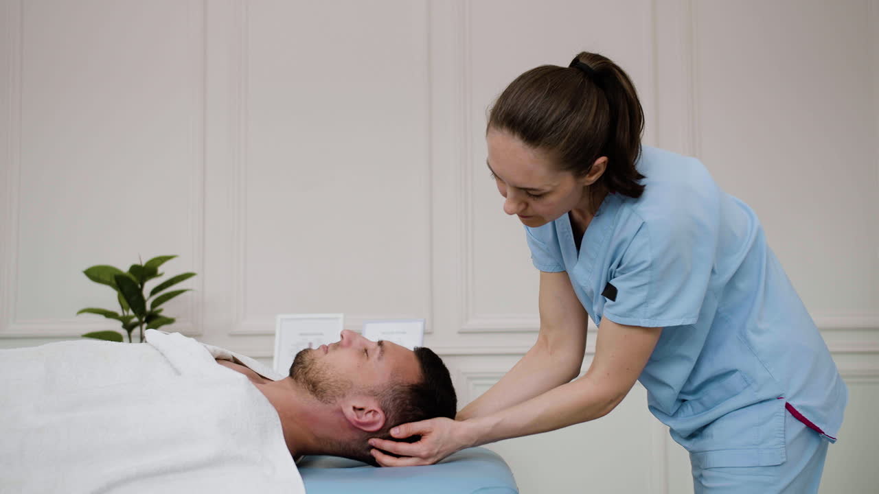 Massage therapist with client