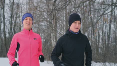 Happy-young-couple-married-sports-morning-and-evening-jogging-in-the-park.