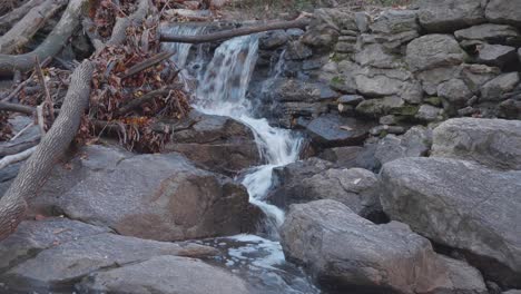 Water-flowing-through-rocks-and-autumn-leaves-in-Wissahickon