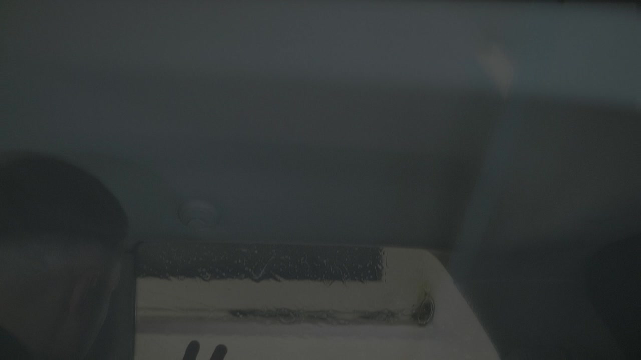 Man fitting tinting foil inside car side windows. Window Tinting Process