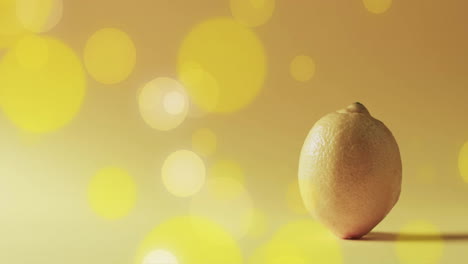 composition of spots of light over lemon on yellow background