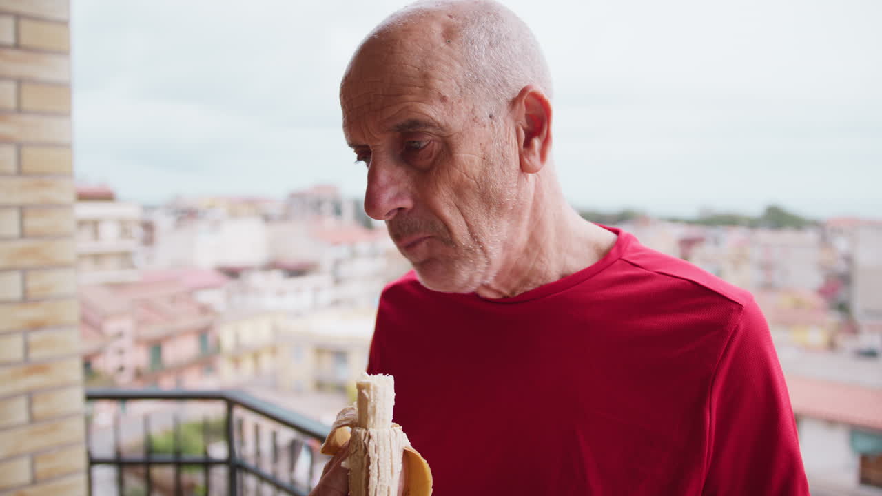 Elderly Man Eats a Banana to Recover After a Workout