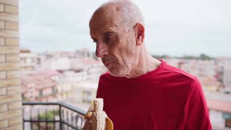 elderly man eats a banana to recover after a workout
