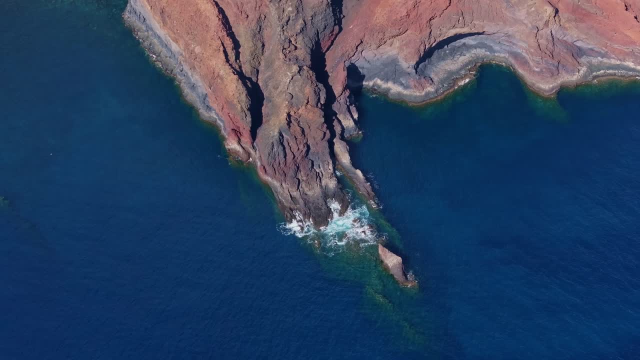 Dramatic Atlantic Ocean coast with red volcanic cliffs in Canary Islands Spain