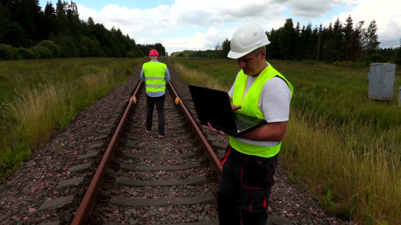 Engineer and worker on railway track
