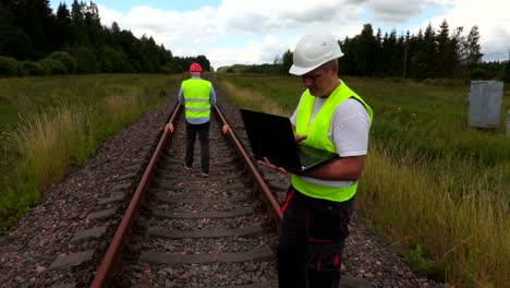 engineer and worker on railway track